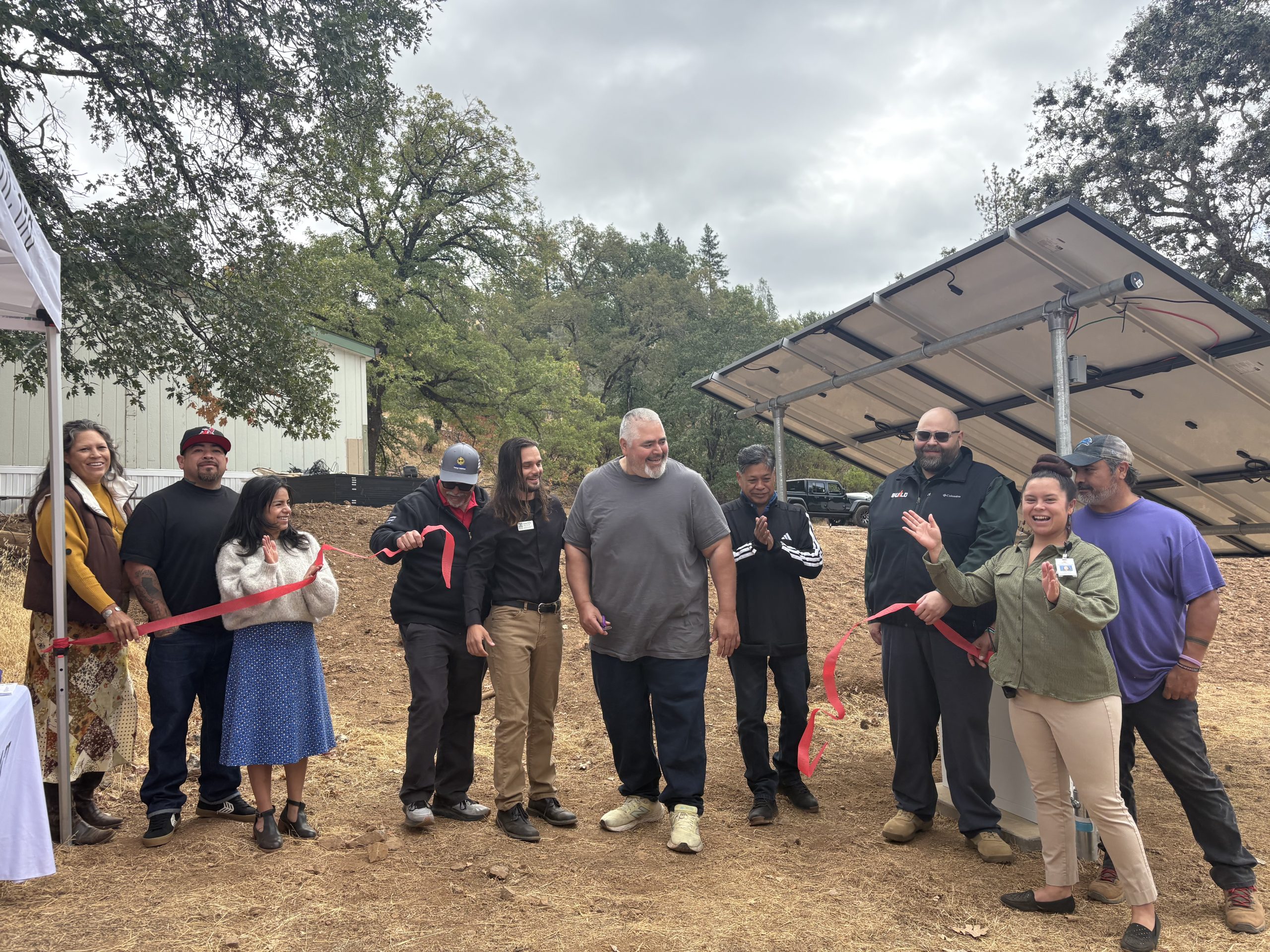 A group of people cutting a ribbon
