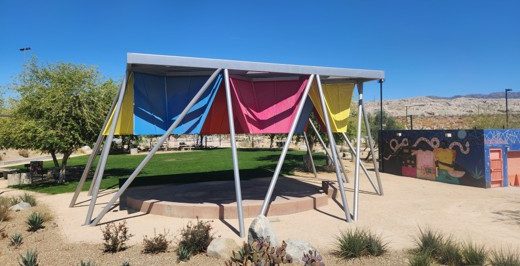 A photo of a shade structure in the desert.