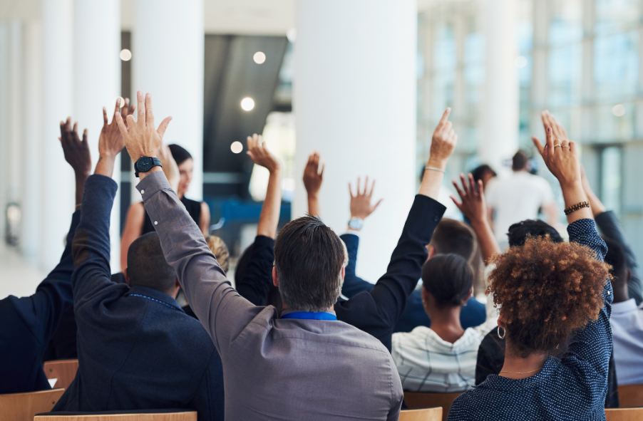 A photo of people raising their hands